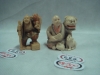 Dois netsukes esculpidos em marfim policromado representando "Amestrador de macaco" e "Homem com mascara de cão de fó e seu cãozinho". Assinados. Japão-1900;