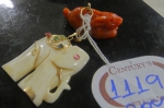 Dois pendentes esculpidos em marfim e coral no feitio de elefante e lebre. Guarnições em ouro 18k.