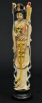 Figura esculpida em marfim policromado, representando "Divindade Kuan Yin com abano e ramo de peônias na mão". Base em madeira. Alt.: 22cm. China - 1900.