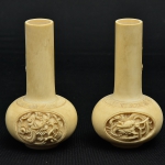 Par de vasos solifleurs esculpidos em marfim com ornamentação em baixo relevo de dragões celestiais. Alt. 10cm. China- séc. XIX.