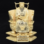 Figura esculpida em marfim representando "Imperador Sentado no Trono". Alt.: 8,5cm. China-1900.