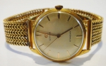 CYMA. Relógio masculino suíço de pulso da década de 50, da marca "Cyma". Caixa e pulseira em ouro 18k. Movimento a corda. Funcionando. Diam.: 3,2cm. Peso: 62,3g.