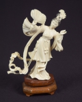 Figura esculpida em marfim, representado "Gueixa com ventarola". Base em madeira. Alt.: 17cm. China - 1900. (Adorno da mão esquerda com lascado).