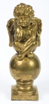 Figura em porcelana europeia revestida em pátina ouro velho, representando "Querubim sentado sobre globo". Alt.: 46cm. (Em função da fragilidade, este lote só poderá ser enviado para fora do estado através de transportadora especializada).