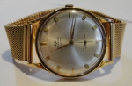 MOVADO. Relógio masculino suíço de pulso automático da marca "Movado" (Década de 60). Caixa e pulseira em ouro 18k. Diam. do mostrador: 3,2cm. Peso: 62,2. Funcionando.