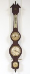 Relógio com barômetro e termômetro da marca "Rubinik". Estrutura em madeira no estilo "Inglês". Alt.: 74cm. (Mecanismo necessitando de revisão e termômetro quebrado).