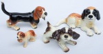 Quatro cachorrinhos miniatura em porcelana alemã policromada da marca "Goebel". Comp. do maior: 14cm. (Em função da fragilidade, este lote só poderá ser enviado para fora do estado através de transportadora especializada).