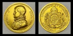 Moeda brasileira em ouro 22k, comemorativa ao "Centenário de Emancipação e Coroação de D. Pedro II" (1815-1915). Peso: 7g.