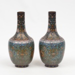 Par de antigos vasos japoneses em cloisoné, fartamente esmaltados com flores orientais, dragões celestiais e gregas sobre fundo azul e negro. Alt.: 37cm. Marca no fundo. (Duas mossas em 1 dos vasos).