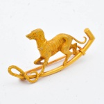 Antigo broche provavelmente francês em ouro 18k, no feitio de "Cãozinho Galgo sobre barra". Comp.: 3,7cm. Peso: 3g.